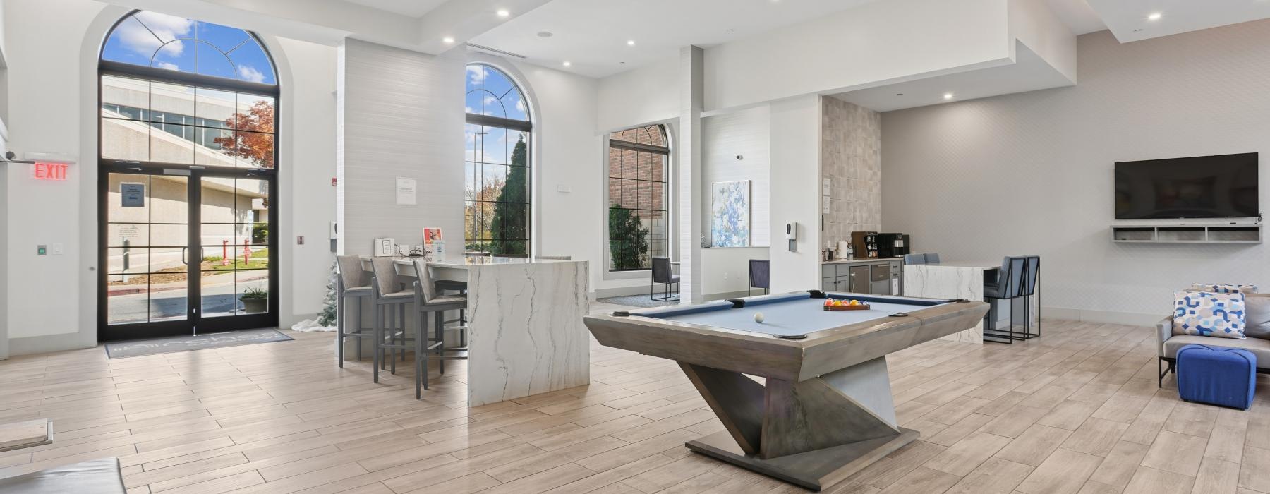 a large room with a pool table and chairs