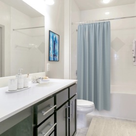 a bathroom with a tub, sink and toilet