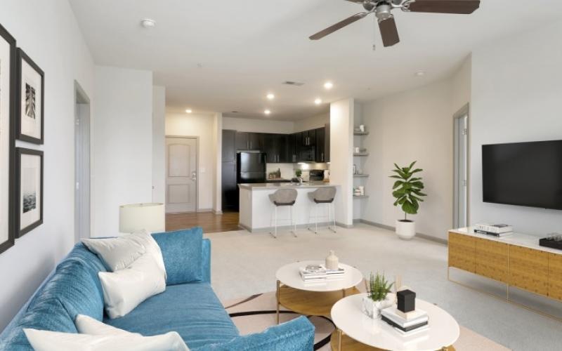 a living room with a blue couch and a tv